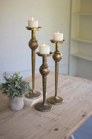 SET OF THREE ANTIQUE BRASS FINISH CANDLE STANDS