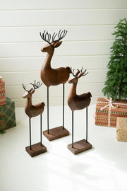 SET OF THREE CARVED WOOD AND IRON REINDEER ON BASES