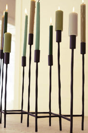 ELEVEN FORGED IRON TAPER CANDELABRA