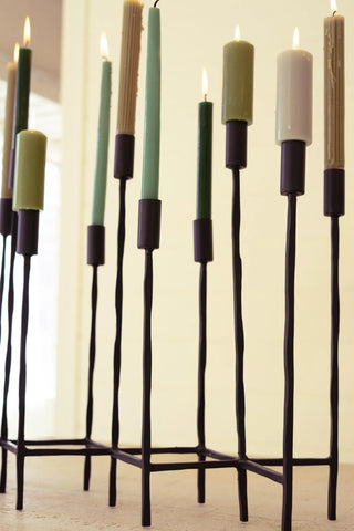 ELEVEN FORGED IRON TAPER CANDELABRA